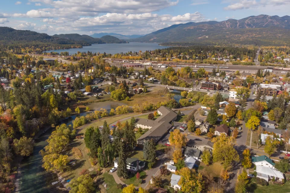 Aerial view of Whitefish, Montana with fall colors and mountains in background.